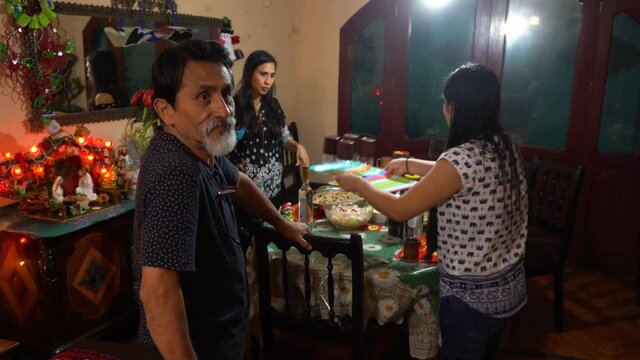 A dad and his daughters setting the table for Christmas dinner