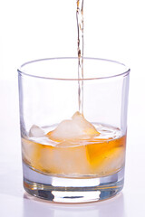 Whiskey poured into a glass