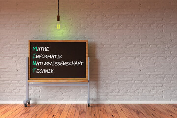 Germany acronym MINT and explanation MATHEMATICS, TECHNOLOGY, SCIENCE and ENGINEERING on a blackboard in front of a brick wall