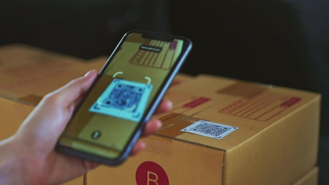 Startup Small Business, Hand Using Smartphone With Scan QR Code On Cardboard Box Delivery For Products To Send To Customers.