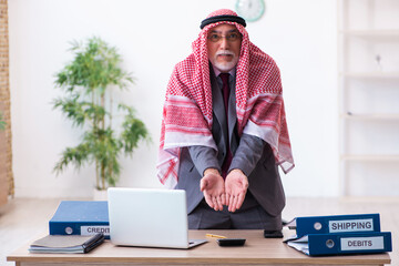 Male arab bookkeeper extremely tired with an excessive work