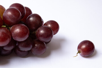 Bunch and berry of red grapes isolated on white background