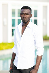 Portrait Smiling african american young businessman CEO standing with serious expression on face