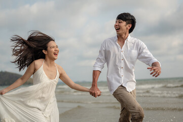 Portrait beach vacation romantic walk couple relaxing on ocean summer travel destination.Young couples are having fun on the beach.Summer in love,Valentine day concept.