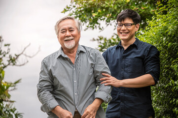 The son helped support his father and talking happily, asian family, life insurance concept.