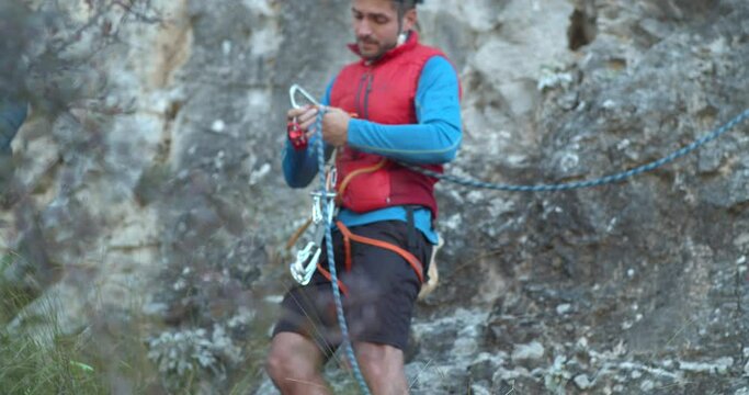 Rock climber putting on his equipment
