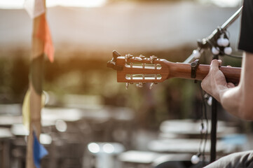 The musicians are checking the sound of the guitar and trying to play the guitar before the event starts. Concert,mini concert and music festivals.