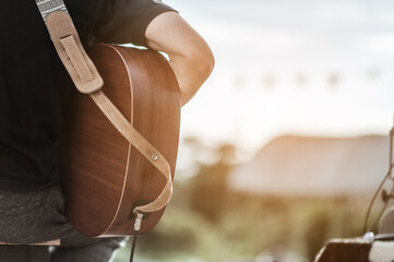 Obraz premium The musicians are checking the sound of the guitar and trying to play the guitar before the event starts. Concert,mini concert and music festivals.