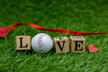 Baseball with love letter on green grass background