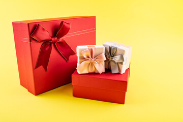 A pile of gift boxes on yellow background