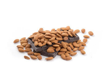 almonds piled onto a slab of raw chocolate as ingredients for a chocolate bar isolated on white



