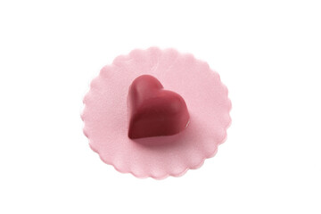 a pink valentines strawberry heart shaped chocolate on a pink doily isolated on white