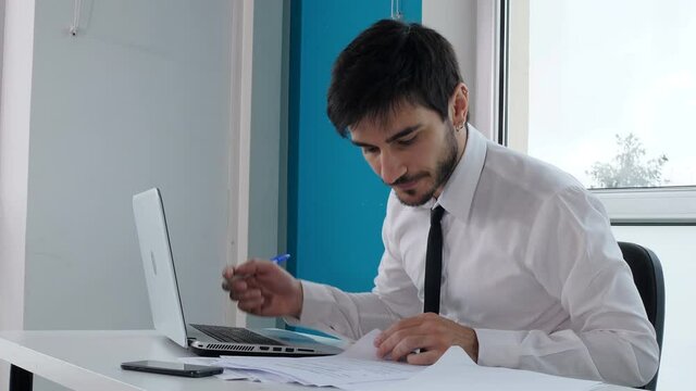 work, problems - stressed manager at computer throws the pen in a rage