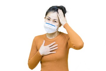 Young asian woman with in orange t-shirt wearing medical face mask under the outbreak of the virus,Have a Headache isolated on white background