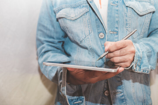 Close up of a man wearing a denim shirt Working through a digital laptop Shows a new normal operation