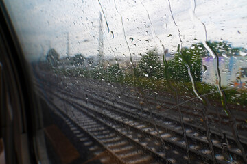 train tracks behind window with rain droplets