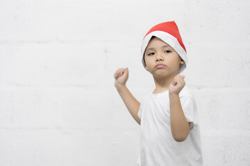 Studio shot of happy little asian boy celebrating holiday