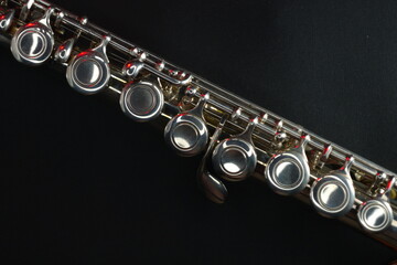 Fototapeta premium Concert flute (part) on dark background with red accent lights