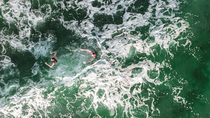 floating people in the black sea of emerald color, rest on the sea