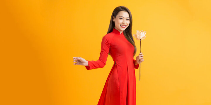 Vietnamese girl holding a lotus flower, The Ao dai ( long-dress Vietnamese) is traditional costume of Vietnamese woman