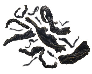 Dried black tea close up levitating on white background