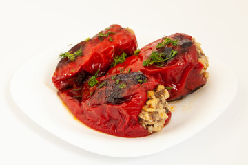 Red peppers stuffed with meat and rice. Filled peppers in white plate