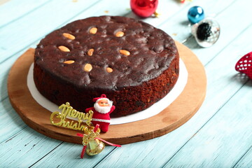 Oven fresh homemade rich plum , dry fruits cake on a holiday background.