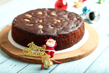 Oven fresh homemade rich plum , dry fruits cake on a holiday background.