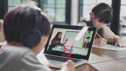 Homeschool Asian little young boy learning online class with teacher - Powered by Adobe