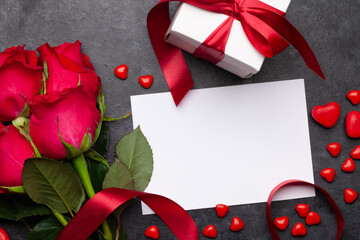 Valentines day greeting card with red rose flowers and gift box
