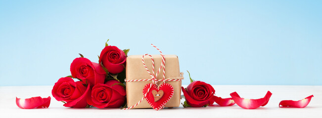 Valentines day greeting card with red rose flowers and gift box