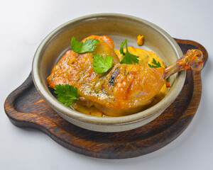 Grilled chicken legs with sauce and gravy in a white bowl over white background. Delicious grilled chicken dinner.