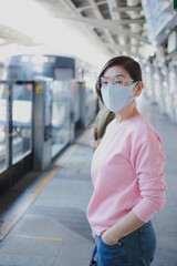 asian woman preparing to wearing protection face mask standing outdoor