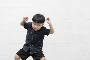 Studio shot portrait of happy little Asian boy on background