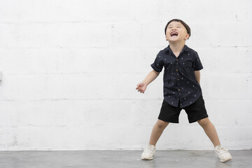 Studio shot portrait of happy little Asian boy on background