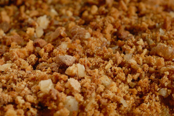 Homemade cream cake sprinkled with nuts closeup. Shallow depth of field