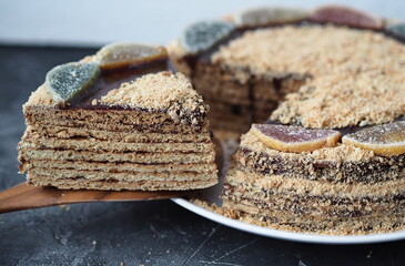 Top view of a round honey cake on a dark wooden background. Rustic food background.