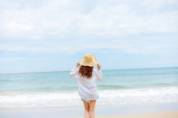 young woman wearing sun hat on the  beach. summer, holidays, vacation, travel concept