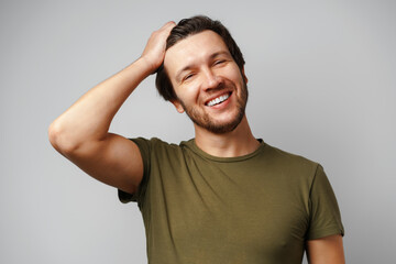 Handsome young man portrait smiling against grey background