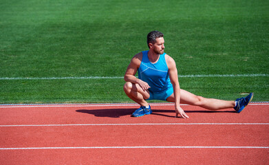 mature man stretching his legs before a stadium workout, stretch