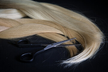 natural hair of different colors with scissors and comb. concept of hair care and hairdressing services