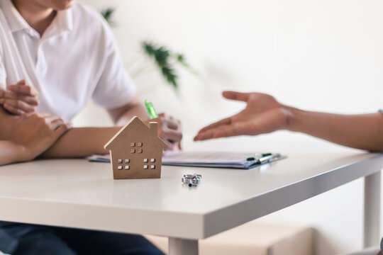 Young couple make contract for new house or apartment with agency