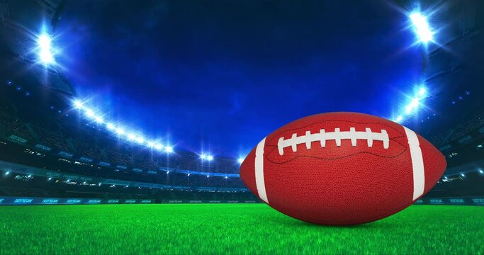 Modern American Football Stadium with shining lights and ball motion on the grass field. Professional sport 4k video background edited as seamless loop.