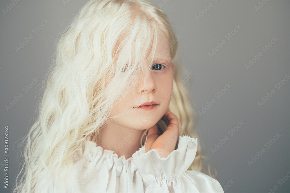 Wall mural sweet kid portrait. natural beauty. carefree childhood. cute happy shy albino blonde little angel gi