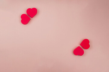 Four red hearts on a pink background