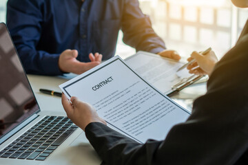 Management members checking candidate's resume after recruitment review