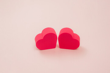  two red hearts on a pink background