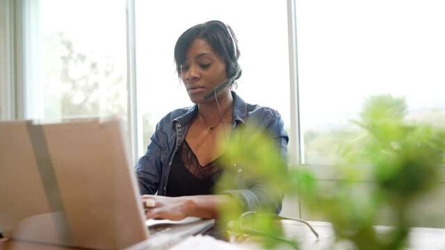 Office worker woman in open space area, protected by plexiglas