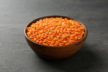 Bowl with legumes on dark wooden background, close up