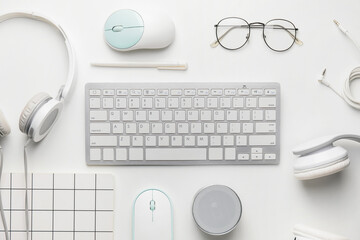 Composition with computer keyboard and different modern devices on white background
